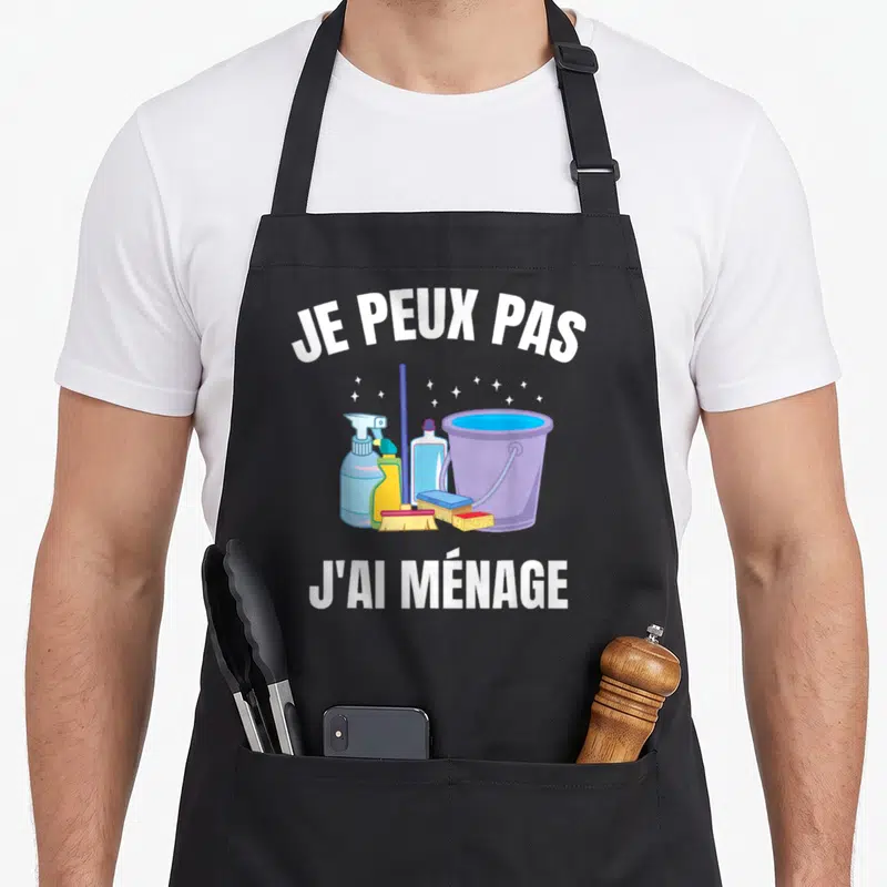 Tablier de cuisine noir avec illustration d'un seau, balai et produits nettoyants sous la phrase je peux pas j'ai ménage.