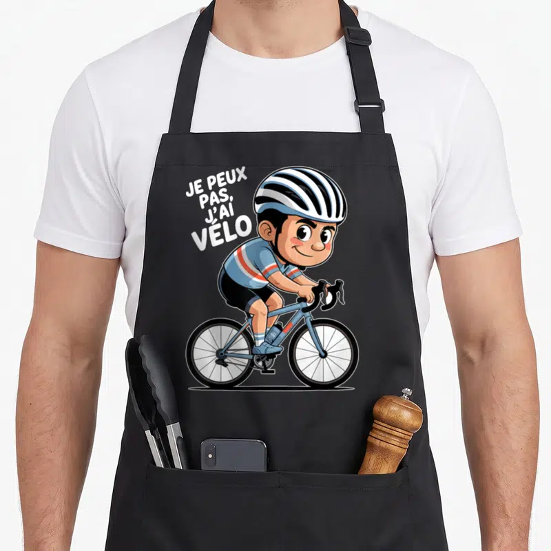 Tablier de cuisine noir avec illustration d'un cycliste souriant et du texte je peux pas j'ai vélo