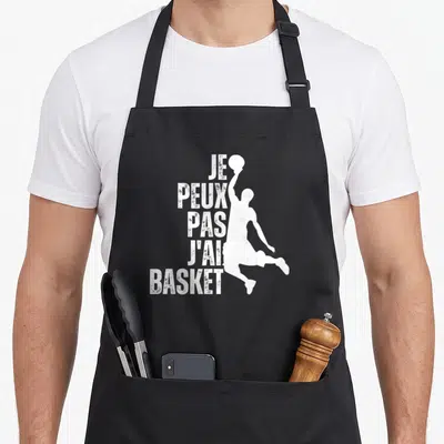 Tablier de cuisine noir avec silhouette blanche de joueur de basket et texte vertical Je Peux Pas J'ai Basket.