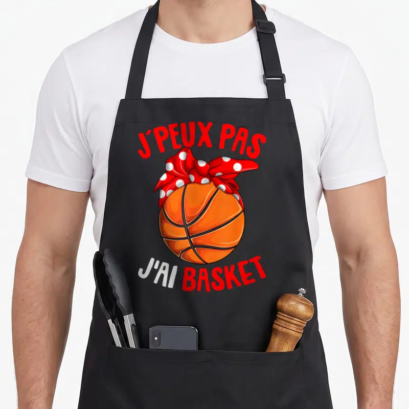 Tablier de cuisine noir avec illustration ballon de basket-ball orange et nœud papillon rouge à pois blancs.
