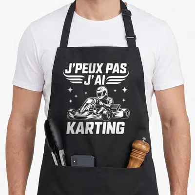 Tablier de cuisine noir avec illustration blanche d'un pilote de karting et le texte j'peux pas j'ai karting.