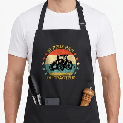 Tablier de cuisine noir avec motif vintage Je peux pas j'ai tracteur et étoiles colorées.