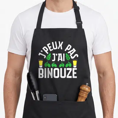 Tablier de cuisine noir avec inscription j'ai binouze encadrée de deux verres de pastis jaunes et de feuilles vertes.