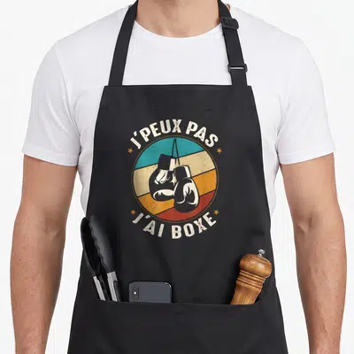 Tablier de cuisine noir avec illustration de gants de boxe et phrase j'ai boxe en style rétro.