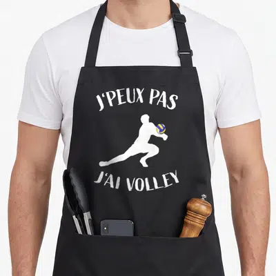 Tablier de cuisine noir avec silhouette blanche joueur de volley et balle jaune bleue.