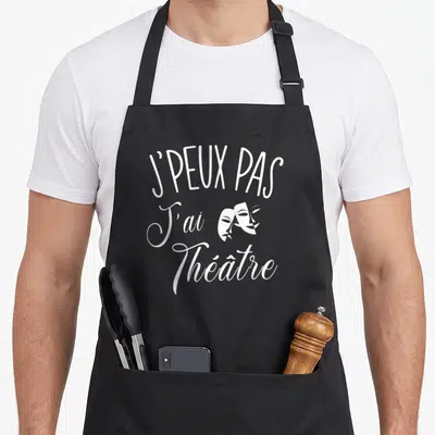 Tablier de cuisine noir avec texte blanc j'peux pas j'ai théâtre et deux masques de comédie.