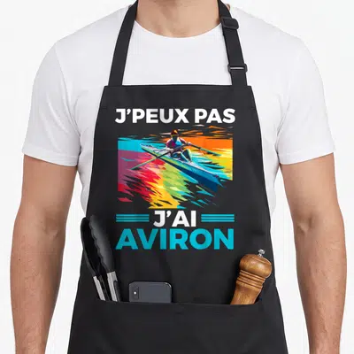 Tablier de cuisine noir avec illustration d'un rameur et texte J'peux pas j'ai aviron en couleurs vives.