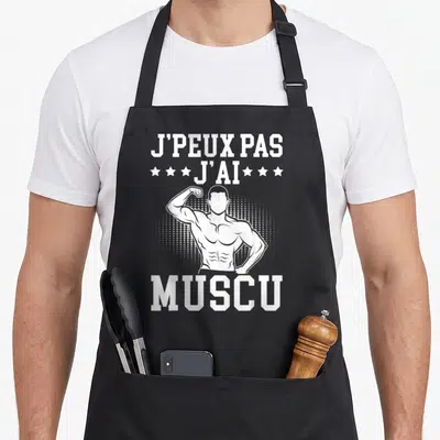 Tablier de cuisine noir avec illustration d'athlète et texte J'peux pas j'ai muscu en blanc.