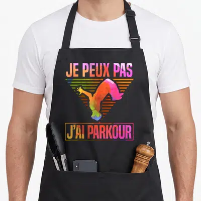 Tablier de cuisine noir avec illustration colorée d'un acrobate et texte je peux pas j'ai parkour