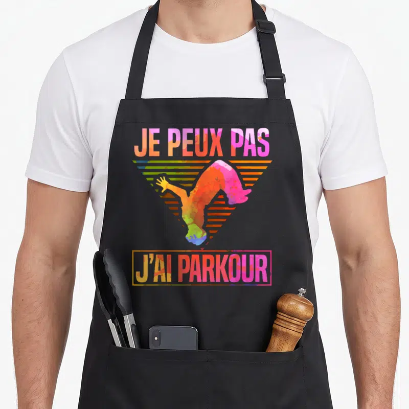 Tablier de cuisine noir avec illustration colorée d'un acrobate et texte je peux pas j'ai parkour