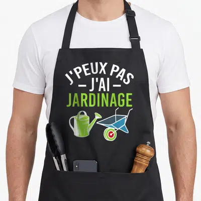 Tablier de cuisine noir avec texte blanc vert et illustrations d'arrosoir et brouette colorées