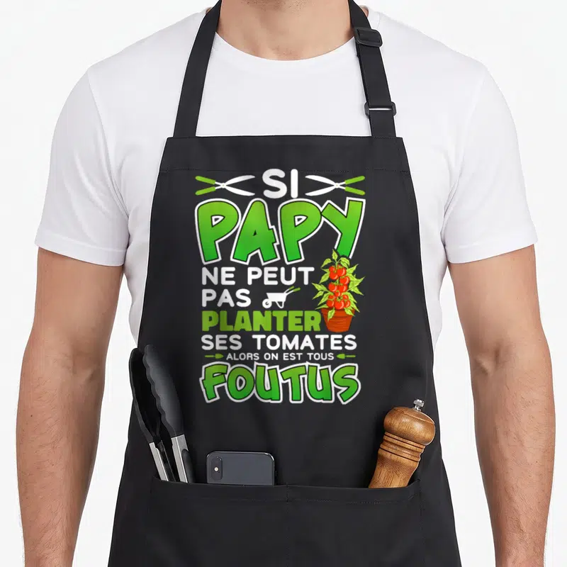 Tablier de cuisine noir avec inscription verte et blanche Si Papy planter tomates foutus illustrée par un potier et une brouette.