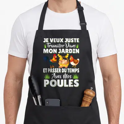 Tablier de cuisine noir avec inscription Je veux juste travailler dans mon jardin avec mes poules et une illustration de volailles colorées.