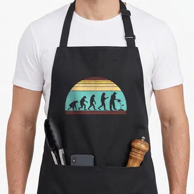 Tablier de cuisine noir avec illustration évolution homme devenant jardinier arrosant une plante sur fond arc-en-ciel vintage