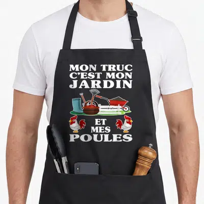 Tablier de cuisine noir avec inscription Mon truc c'est mon jardin et mes poules et illustration de brouette et poules.