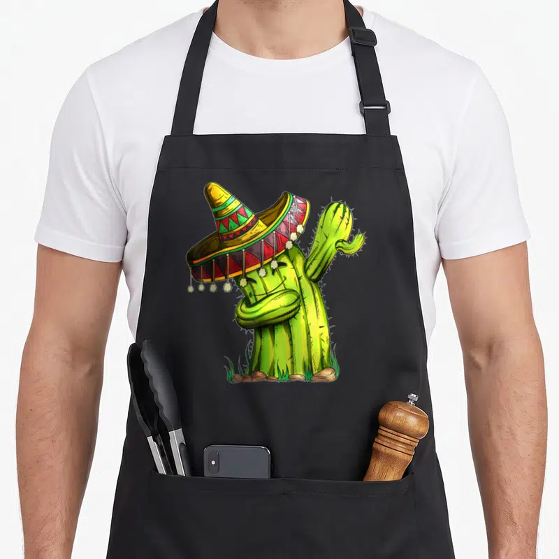Tablier de cuisine noir avec illustration d'un cactus vert coiffé d'un sombrero mexicain multicolore.