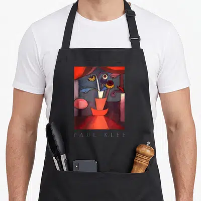 Tablier de cuisine noir avec une reproduction colorée de l'œuvre Paul Klee Fleur d'automne sur le devant.
