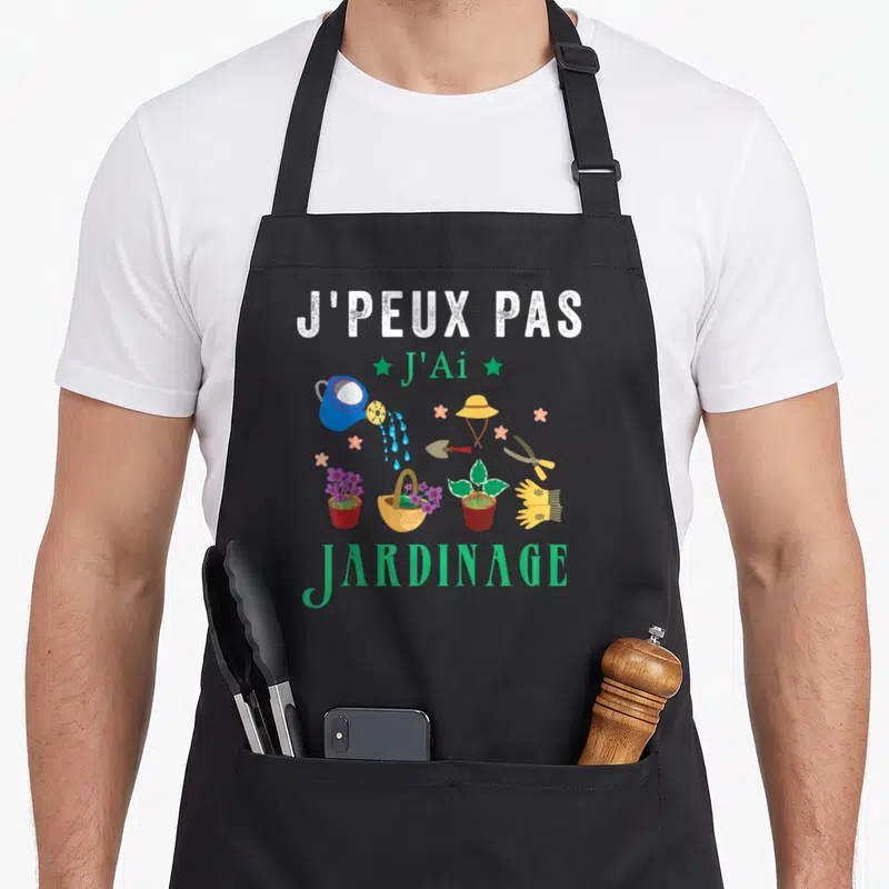 Tablier de cuisine noir avec inscription Je peux pas j'ai jardinage et illustrations d'outils de potier colorés.