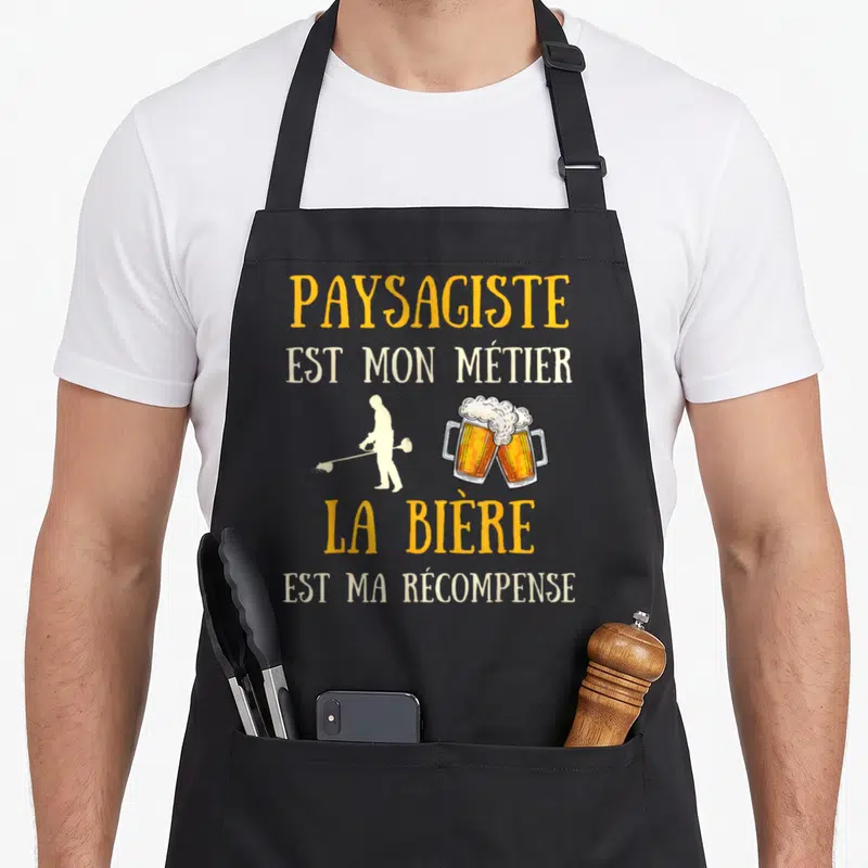 Tablier de cuisine noir avec texte jaune et blanc paysagiste métier bière récompense et silhouette homme travailleur.