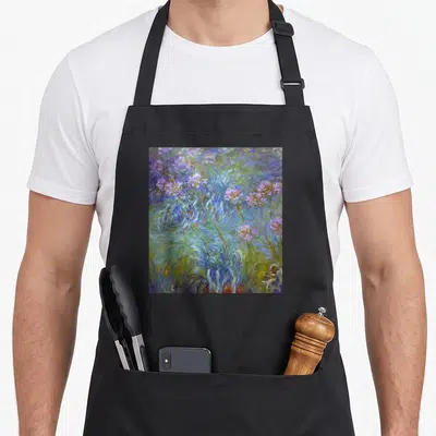 Tablier de cuisine noir avec une impression artistique représentant des agapanthes colorées dans un style pictural fluide et végétal.