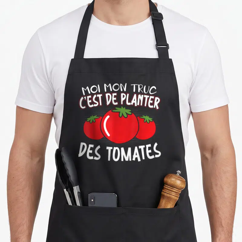 Tablier de cuisine noir avec trois tomates rouges stylisées et texte blanc humoristique sur le jardinage.
