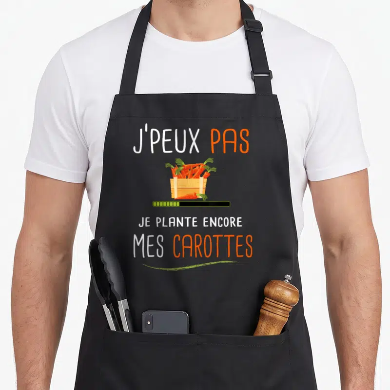 Tablier de cuisine noir avec illustration de carottes dans une caisse et texte J'peux pas je plante encore mes carottes