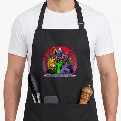 Tablier de cuisine noir avec illustration colorée d'une fleur et d'un zombie végétal combatant ensemble.