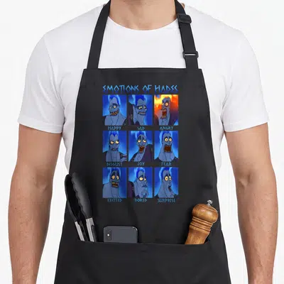 Tablier de cuisine noir avec une grille de neuf visages bleus de Hades affichant diverses émotions sous le titre Emotions of Hades.