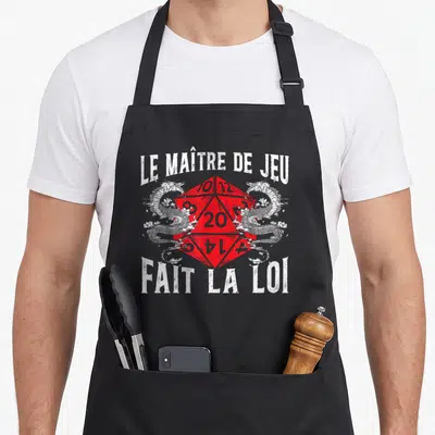 Tablier de cuisine noir avec un dé rouge à faces encadré par deux dragons blancs et le texte Le Maître de Jeu fait la loi.