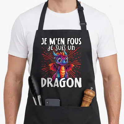 Tablier de cuisine noir avec un dragon multicolore aux ailes déployées et le texte Je m'en fous je suis un dragon en blanc.