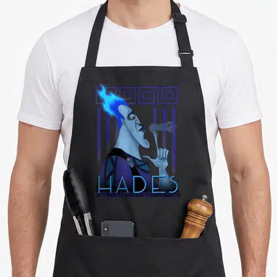 Tablier de cuisine noir avec portrait géométrique d'Hadès aux cheveux bleus et texte HADES en bas.