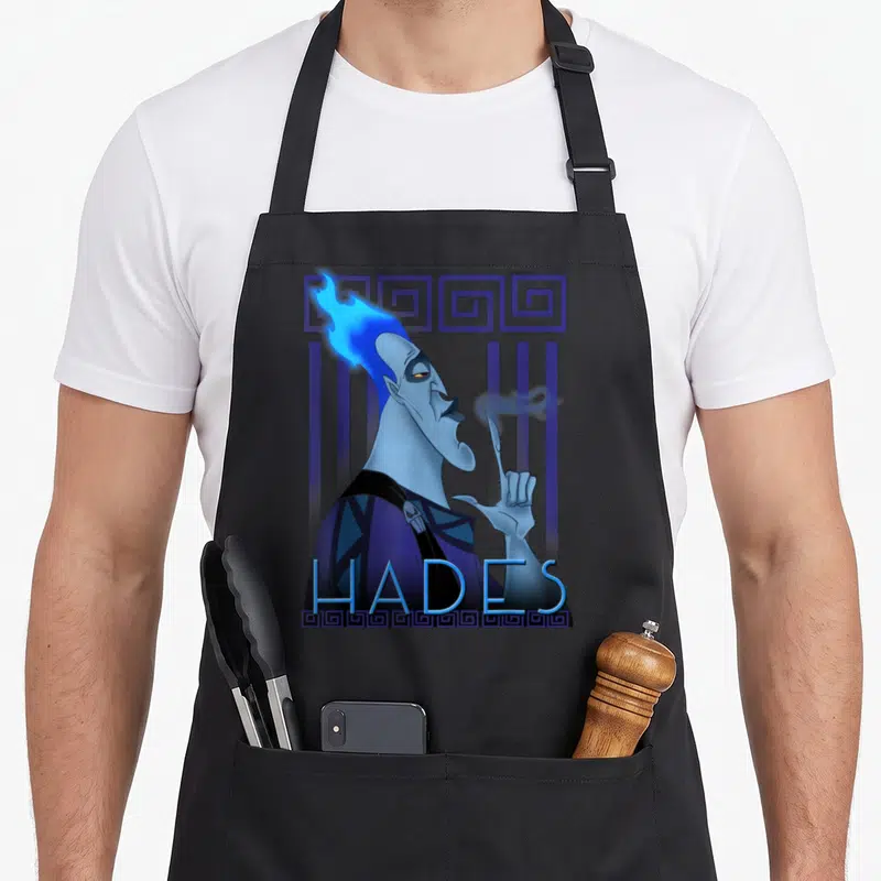 Tablier de cuisine noir avec portrait géométrique d'Hadès aux cheveux bleus et texte HADES en bas.