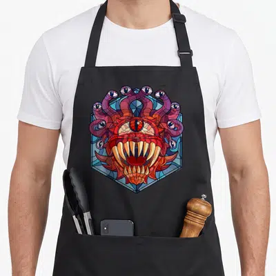 Tablier de cuisine noir avec illustration Beholder vitrail aux couleurs vives et détails oculaires complexes.