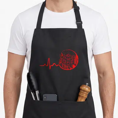 Tablier de cuisine noir avec un D20 rouge et une ligne de battement de cœur stylisée.
