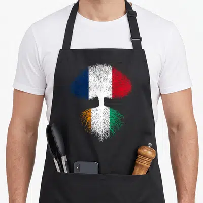 Tablier de cuisine noir avec un arbre stylisé aux couleurs des drapeaux français et ivoirien représentant racines et branches.