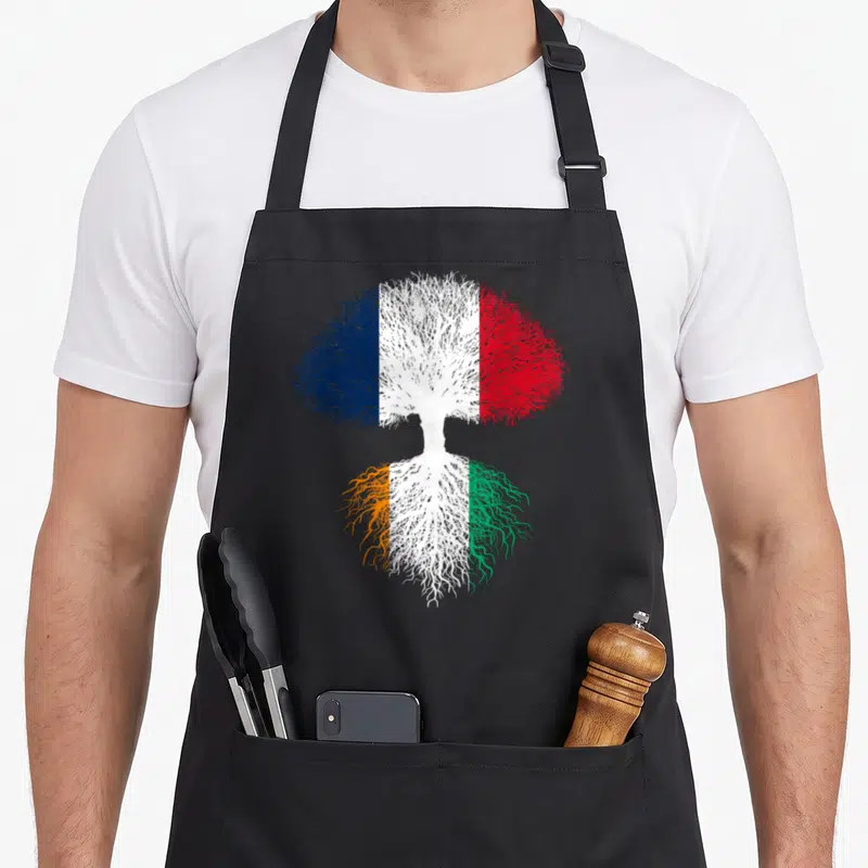 Tablier de cuisine noir avec un arbre stylisé aux couleurs des drapeaux français et ivoirien représentant racines et branches.