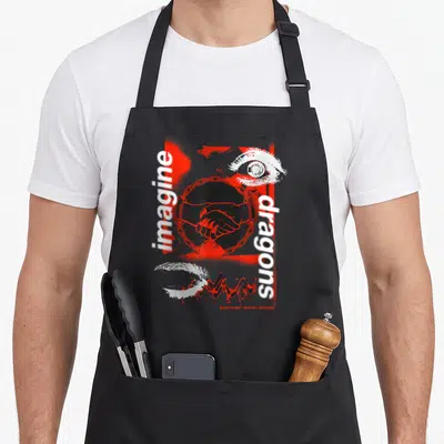 Tablier de cuisine noir avec une poignée de main, un œil et les mots imagine dragons en rouge et blanc.