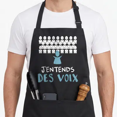 Tablier de cuisine noir avec illustration d'un chœur et le texte J'entends des voix en blanc et bleu.