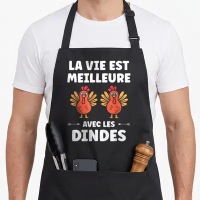 Tablier de cuisine noir avec deux dindes rouges et le texte la vie est meilleure avec les dindes en blanc.