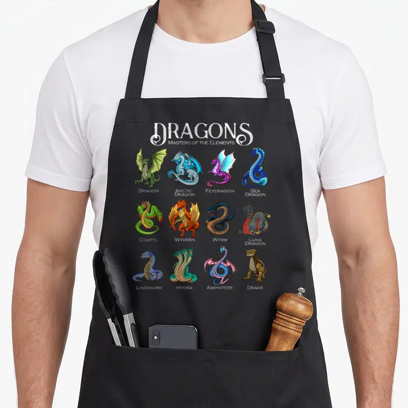 Tablier de cuisine noir avec douze illustrations colorées de dragons fantastiques et leurs noms anglais sous chaque dessin.