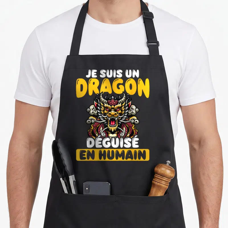 Tablier de cuisine noir avec illustration de dragon asiatique coloré et texte Je Suis Un Dragon Déguisé En Humain en lettres jaunes et blanches.