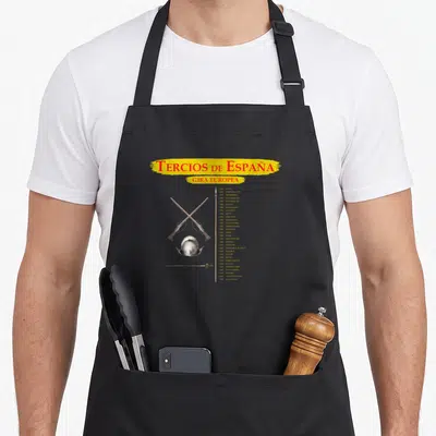 Tablier de cuisine noir avec illustration de casque, fusils croisés et texte Tercios de España sur fond gris uni.