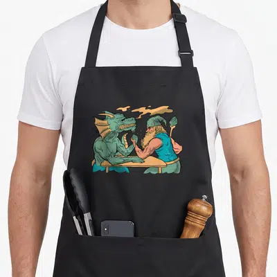 Tablier de cuisine noir avec illustration d'un dragon et d'un sorcier en arm wrestling coloré.