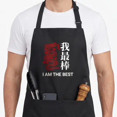 Tablier de cuisine noir avec un dragon rouge stylisé et le texte blanc I AM THE BEST en bas.