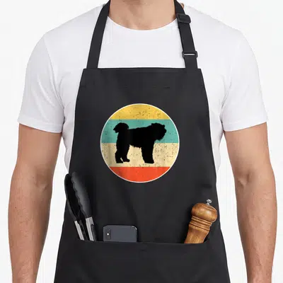 Tablier de cuisine noir avec silhouette Bouvier des Flandres sur fond circulaire rétro multicolore