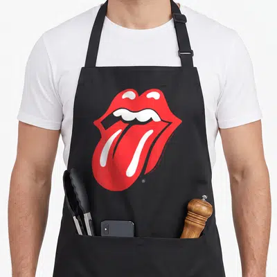 Tablier de cuisine noir avec une grande illustration rouge et blanche représentant une bouche ouverte et une langue saillante.
