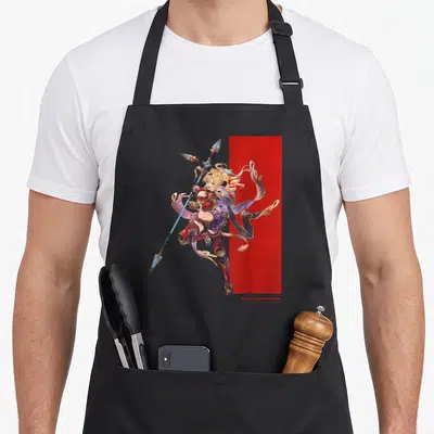 Tablier de cuisine noir avec illustration d'une guerrière blonde tenant une lance bleue sur fond rouge et gris.