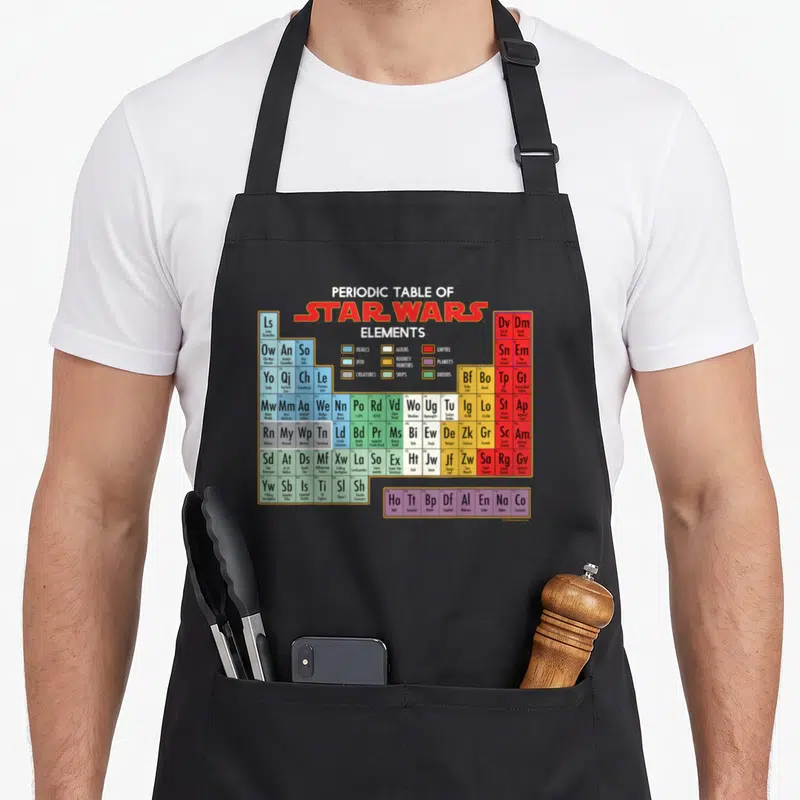 Tablier de cuisine noir avec un tableau périodique des éléments Star Wars coloré et détaillé.