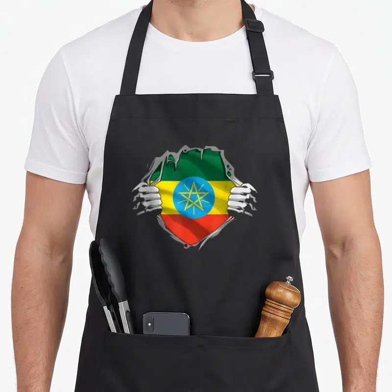 Tablier Drapeau des racines de l'Éthiopie Super Héritage éthiopien — sur un tablier de cuisine noir, fond blanc