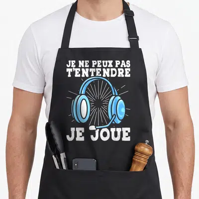 Tablier de cuisine noir avec illustration de casque audio bleu et texte blanc humoristique sur fond uni.
